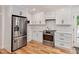 Bright kitchen with white cabinets, stainless steel appliances, and a gas range with white subway tile backsplash at 318 Hepowil Trce, Hillsborough, NC 27278