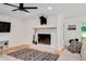 A living room featuring a fireplace with wooden mantel, hardwood floors, and white painted brick at 318 Hepowil Trce, Hillsborough, NC 27278
