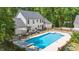 Backyard with in-ground pool, patio with seating, and fencing that creates a private outdoor oasis at 318 Hepowil Trce, Hillsborough, NC 27278