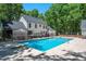 Backyard pool with lounge chairs surrounded by a black metal fence, offering a private retreat at 318 Hepowil Trce, Hillsborough, NC 27278