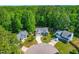 Aerial view of neighborhood showing surrounding mature trees, well maintained lawns, and winding streets at 33 Carrington Cir, Angier, NC 27501