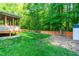 Expansive backyard with a new wooden fence, lawn, mature trees and storage shed at 33 Carrington Cir, Angier, NC 27501