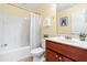 Bathroom with a shower-tub combo and cherry-wood vanity at 33 Carrington Cir, Angier, NC 27501