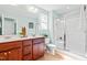 Well-lit bathroom with a double vanity and glass door shower at 33 Carrington Cir, Angier, NC 27501