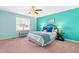Bright bedroom with blue walls, a white bed with blue accents, and a window with natural light at 33 Carrington Cir, Angier, NC 27501