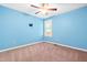 Bright bedroom with neutral carpet, ceiling fan, and light-blue painted walls at 33 Carrington Cir, Angier, NC 27501