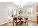 Dining area with a glass table, seating for four, a chandelier, and sliding glass doors to the outside at 33 Carrington Cir, Angier, NC 27501