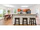 Charming kitchen with wood cabinets, stainless appliances, granite countertops, and a breakfast bar with stools at 33 Carrington Cir, Angier, NC 27501