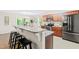 Kitchen with stainless appliances, wood cabinets, granite counters, a breakfast bar, and view of dining area at 33 Carrington Cir, Angier, NC 27501