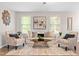 Bright living room with neutral decor and comfortable seating arrangement at 33 Carrington Cir, Angier, NC 27501