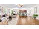Open-concept living room and kitchen area with hardwood floors, modern furniture, and lots of natural light at 33 Carrington Cir, Angier, NC 27501