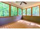 Enclosed porch offering views of the green forest at 33 Carrington Cir, Angier, NC 27501