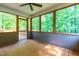 Enclosed porch offering views of the green forest at 33 Carrington Cir, Angier, NC 27501
