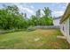 Expansive backyard with lush lawn, mature trees, and a private fence at 334 Huckleberry Loop, Mebane, NC 27302