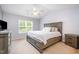 Spacious bedroom with a large bed, soft lighting, and a view of the outdoors at 334 Huckleberry Loop, Mebane, NC 27302