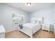 Light bedroom with a queen-sized bed, a bright window, and a soothing color palette at 334 Huckleberry Loop, Mebane, NC 27302