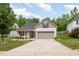 Charming home with a well-manicured lawn, two-car garage, and inviting curb appeal at 334 Huckleberry Loop, Mebane, NC 27302