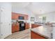Well-lit kitchen with wooden cabinets, modern appliances, and sleek countertops at 334 Huckleberry Loop, Mebane, NC 27302