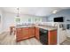 Open-concept kitchen featuring a breakfast bar, stainless steel appliances, and a tiled backsplash at 334 Huckleberry Loop, Mebane, NC 27302
