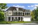 Charming two-story home with covered front porch, green lawn, black shutters and attached two car garage at 3415 Great Smoky Pl, Lillington, NC 27546