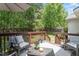 Relaxing outdoor deck features comfortable seating, ambient string lights, and a serene backyard view at 3810 Stoneybrook Dr, Durham, NC 27705