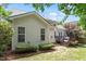 Backyard view shows a deck, well-kept lawn and landscaped border surrounding the perimeter of the property at 3810 Stoneybrook Dr, Durham, NC 27705