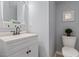 Neutral-toned bathroom features vanity with sink and white toilet at 3810 Stoneybrook Dr, Durham, NC 27705