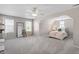 This spacious bedroom features neutral walls, carpet, 3 windows with curtains, and a bed with colorful pillows at 3810 Stoneybrook Dr, Durham, NC 27705