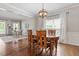 Traditional dining room featuring wood floors, a round table, and a modern light fixture at 3810 Stoneybrook Dr, Durham, NC 27705
