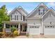 Inviting home exterior showcases a covered porch, dual garage, manicured lawn and delightful landscaping at 3810 Stoneybrook Dr, Durham, NC 27705