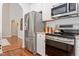 Modern kitchen features stainless steel appliances, tiled backsplash, and hardwood flooring at 3810 Stoneybrook Dr, Durham, NC 27705