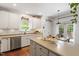 Updated kitchen features stainless steel appliances, white cabinetry, and eat-in breakfast nook at 3810 Stoneybrook Dr, Durham, NC 27705