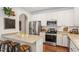 Eat-in kitchen featuring bar stool seating, modern appliances, and sleek countertops at 3810 Stoneybrook Dr, Durham, NC 27705