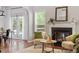 Cozy living room featuring a fireplace, comfortable seating, and views of the outdoors at 3810 Stoneybrook Dr, Durham, NC 27705