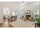 Open-concept living room with fireplace and archways leading to other rooms in the home at 3810 Stoneybrook Dr, Durham, NC 27705