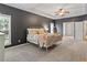 Spacious main bedroom features soft carpet, a tray ceiling, and multiple windows at 3810 Stoneybrook Dr, Durham, NC 27705