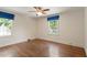 Spacious bedroom with hardwood floors, neutral paint, and dual windows allowing for natural light at 400 Bowling Creek Rd, Chapel Hill, NC 27514