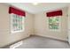 A cozy bedroom features neutral carpeting, two large windows, and elegant trim and paint details at 400 Bowling Creek Rd, Chapel Hill, NC 27514
