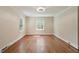 Bedroom with hardwood floors, neutral paint, and dual windows allowing for natural light at 400 Bowling Creek Rd, Chapel Hill, NC 27514
