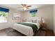 Comfortable bedroom with a ceiling fan, a decorative rug, and dual windows with blue fabric blinds at 400 Bowling Creek Rd, Chapel Hill, NC 27514