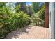 Wood deck overlooks a lush, landscaped backyard with mature trees and plantings at 400 Bowling Creek Rd, Chapel Hill, NC 27514