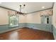 Charming dining room with hardwood floors, blue wainscoting, and large window with patterned valance at 400 Bowling Creek Rd, Chapel Hill, NC 27514