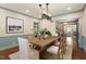 Elegant dining room featuring hardwood floors, chandelier lighting, and wainscoting details at 400 Bowling Creek Rd, Chapel Hill, NC 27514