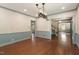 Open-concept dining room with hardwood floors, blue wainscoting, and views to additional rooms at 400 Bowling Creek Rd, Chapel Hill, NC 27514
