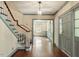 Inviting foyer with hardwood floors, staircase, and a glimpse of the living room at 400 Bowling Creek Rd, Chapel Hill, NC 27514