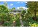 Charming two-story home with a stone path, mature landscaping, and solar panels on the roof at 400 Bowling Creek Rd, Chapel Hill, NC 27514