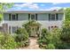 Charming two-story home with mature landscaping and a welcoming stone walkway to the front door at 400 Bowling Creek Rd, Chapel Hill, NC 27514