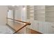 Upstairs hallway featuring hardwood floors, and a built-in bookcase with white cabinets at 400 Bowling Creek Rd, Chapel Hill, NC 27514