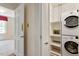 Convenient laundry room with stacked washer and dryer, and storage space, located near the bedroom at 400 Bowling Creek Rd, Chapel Hill, NC 27514