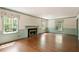 Bright living room with fireplace, hardwood floors and large windows at 400 Bowling Creek Rd, Chapel Hill, NC 27514